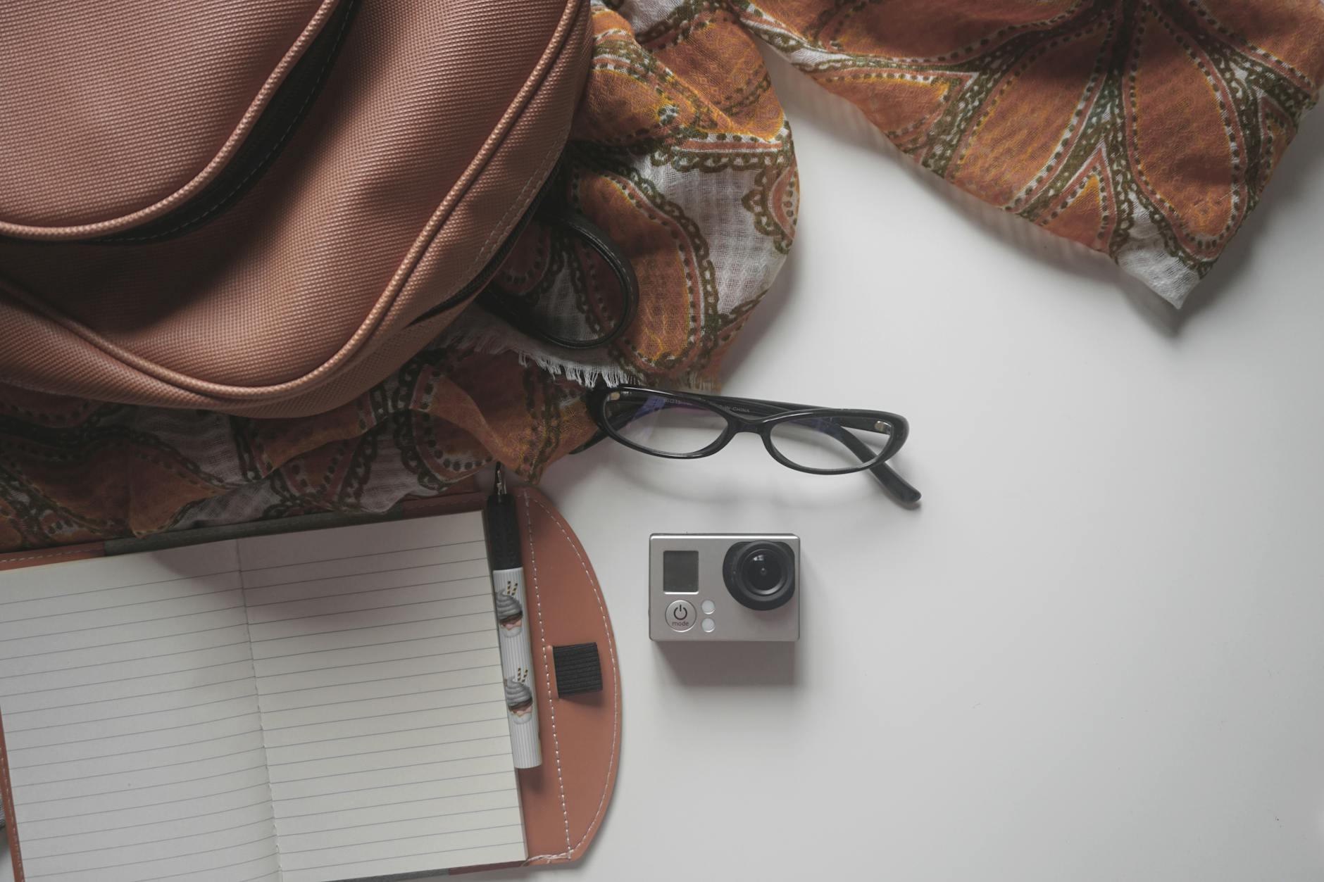 https://www.pexels.com/photo/black-eyeglasses-on-top-of-the-gray-and-black-action-camera-in-the-white-surface-163033/