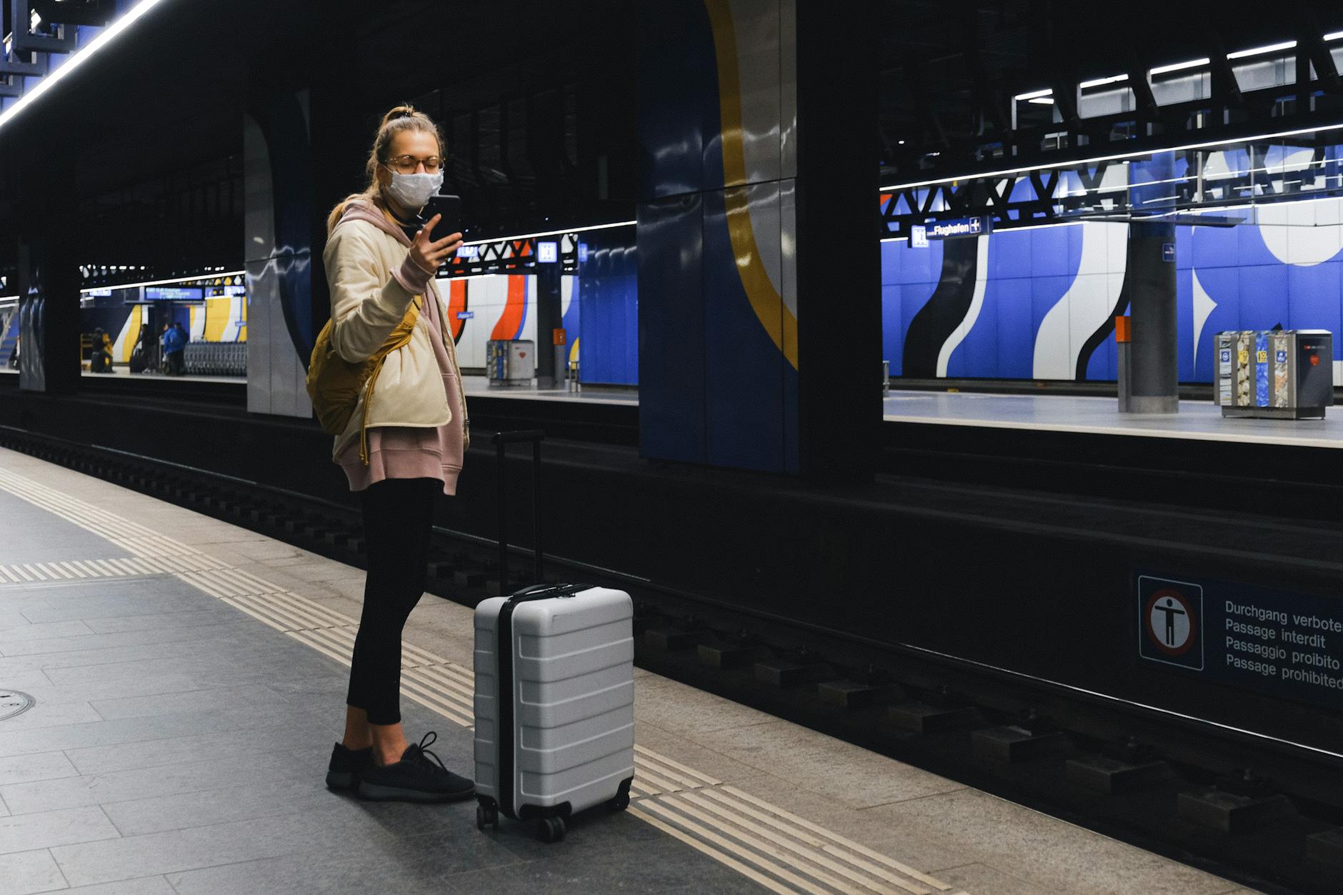 https://www.pexels.com/photo/woman-with-a-face-mask-standing-on-train-station-3943948/