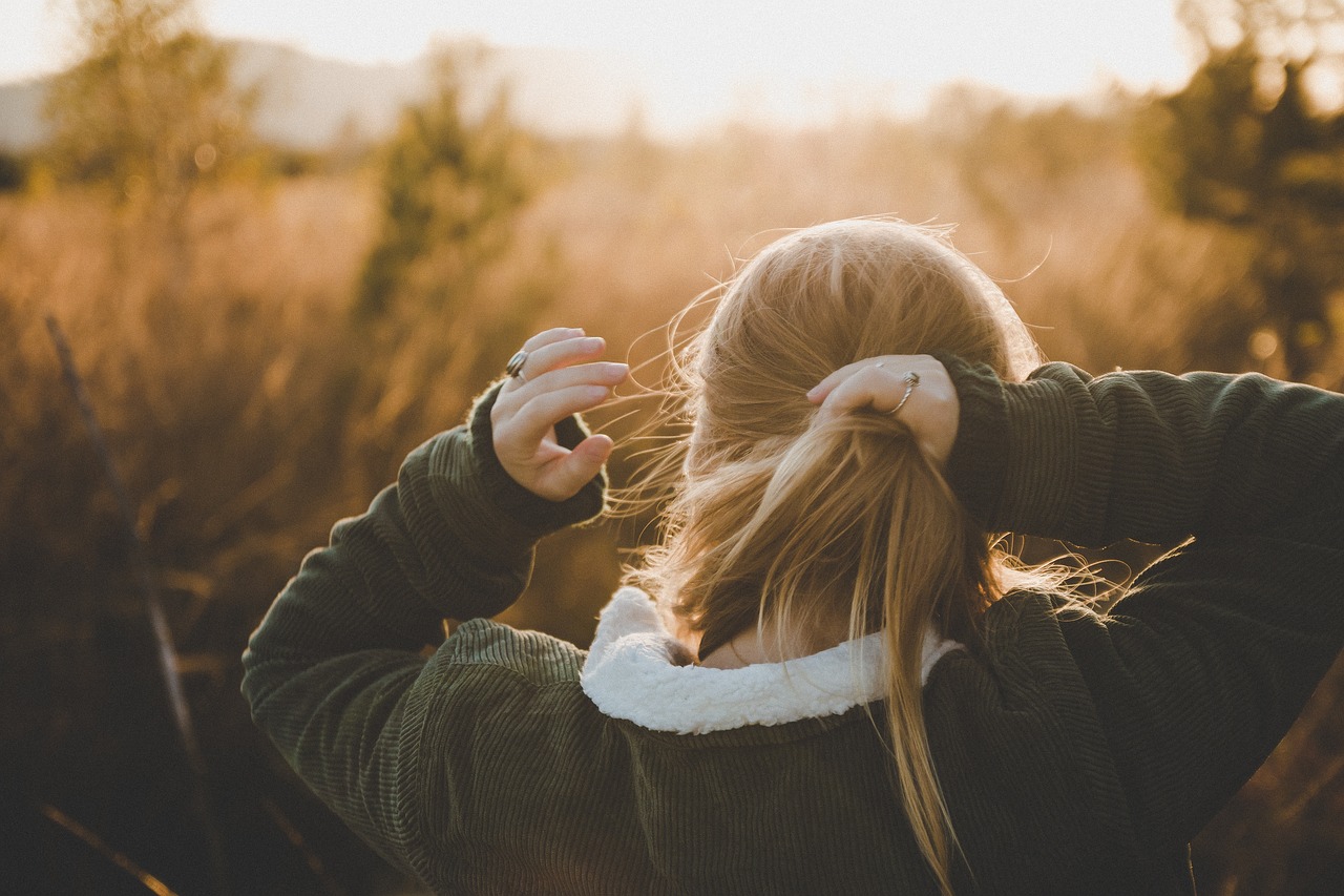 Girl with her locks who revitalize her hair after winter with seasonal hair care tips